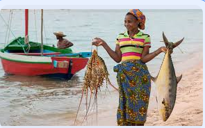 A woman by the lake holding fish