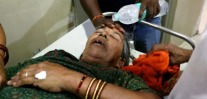 A staff pouring water on a patient 