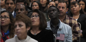 Immigrants listenning to a speech.