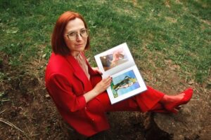 A woman sitting down reading a visual book