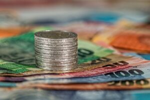 A stack of coins on bank notes