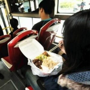 A child enjoy a snack on a bus