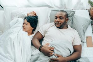 A couple in bed together sleeping