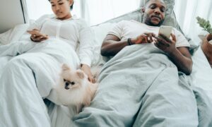 couple in bed with their phones