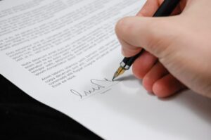 A person sighning a contract