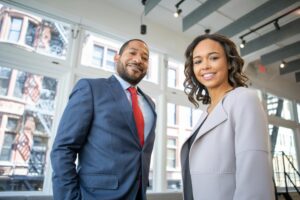 A man and woman wearing suits