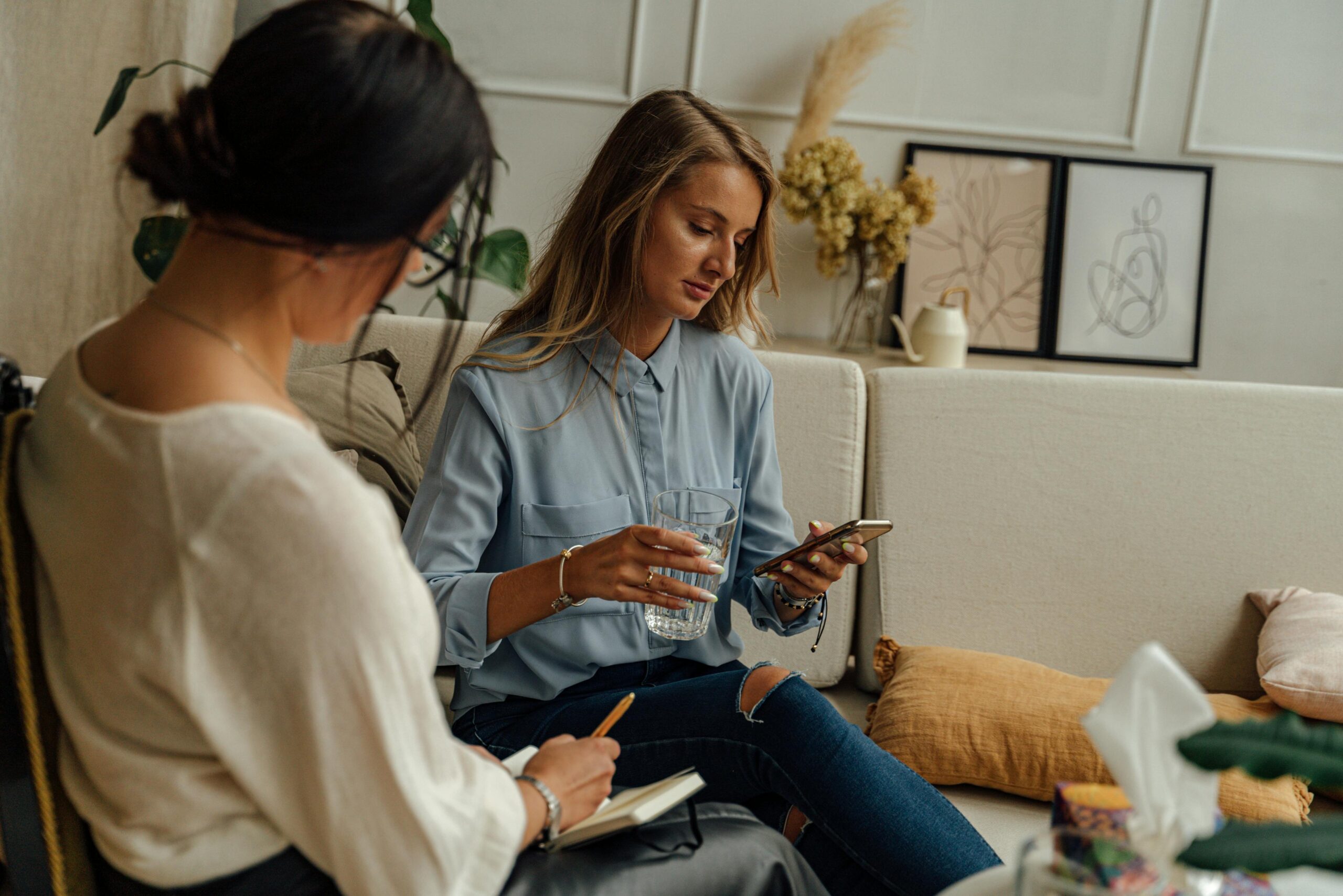 Woman on her phone while talking to a therapist