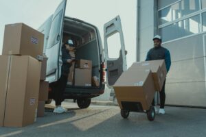 A worker loading boxes in a van