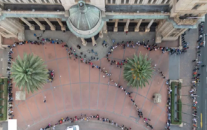 A photo of people queuing to vote