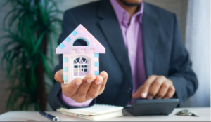 A man holding a small house