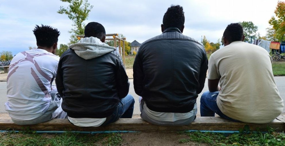 Immigrants sitted outside after work