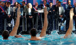 President Macron with other government officials and swimmers during the opening of Olympic Aquatic Center.